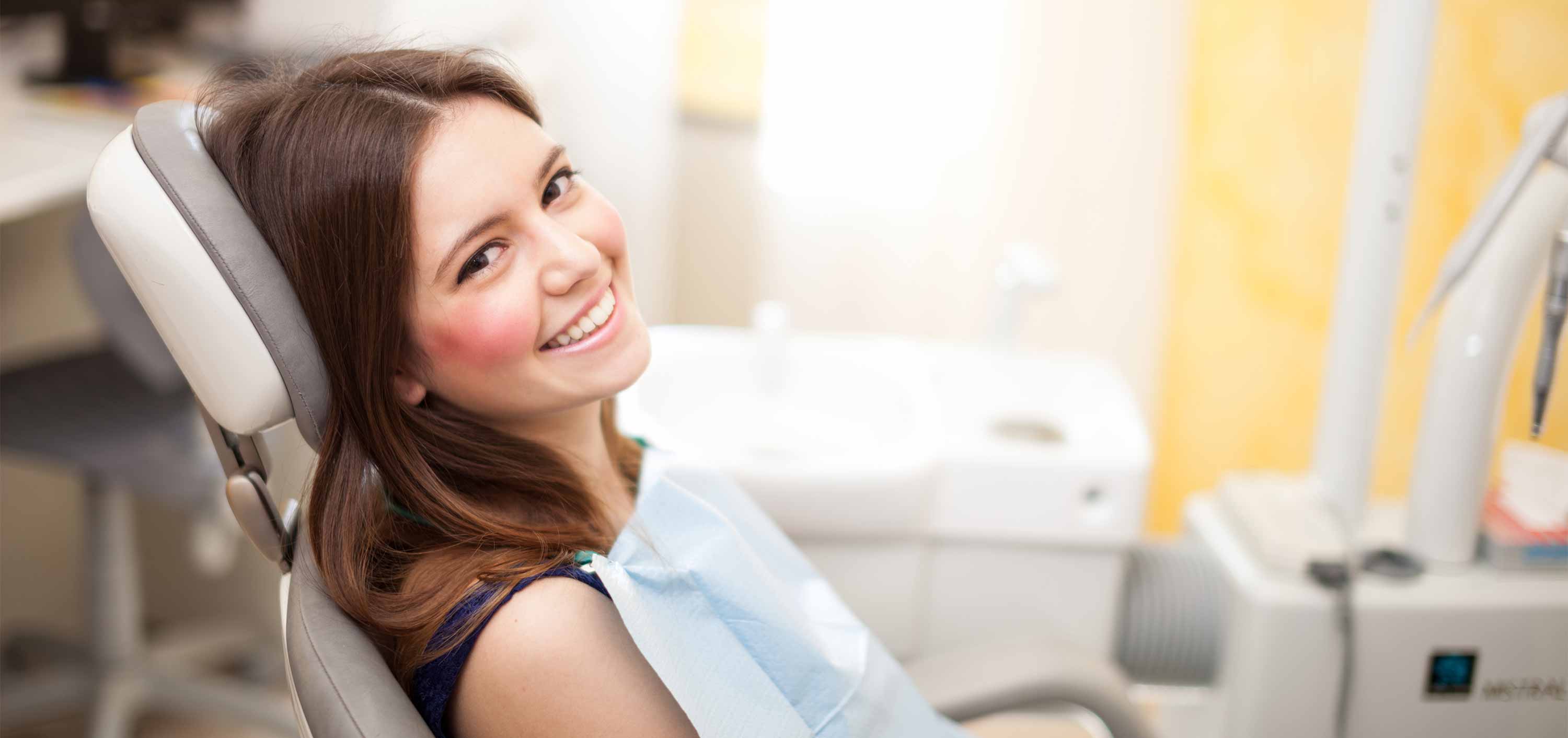 Young woman smiling at her dental cleaning